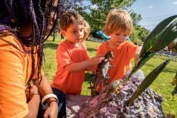 Photo of student talking with two young children.