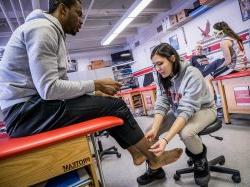 Photo of athletic training students assisting athletes.