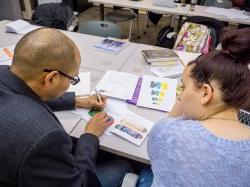 Photo of a student and professor in a visual communications class